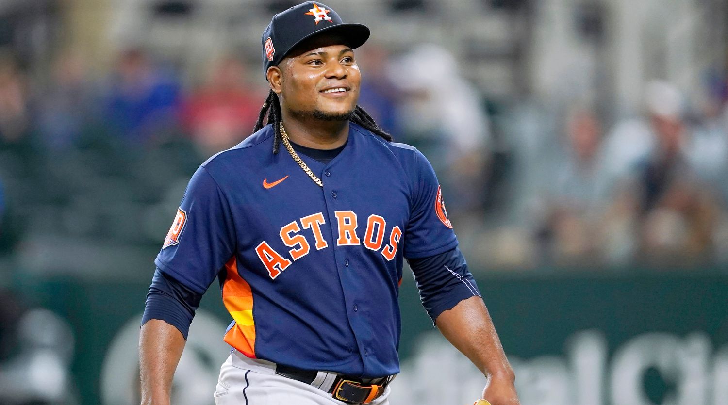 Houston Astros’ Framber Valdez smiles as he walks to the dugout after working against the Texas Rangers during the eighth inning of a baseball game in Arlington, Texas, Tuesday, Aug. 30, 2022.